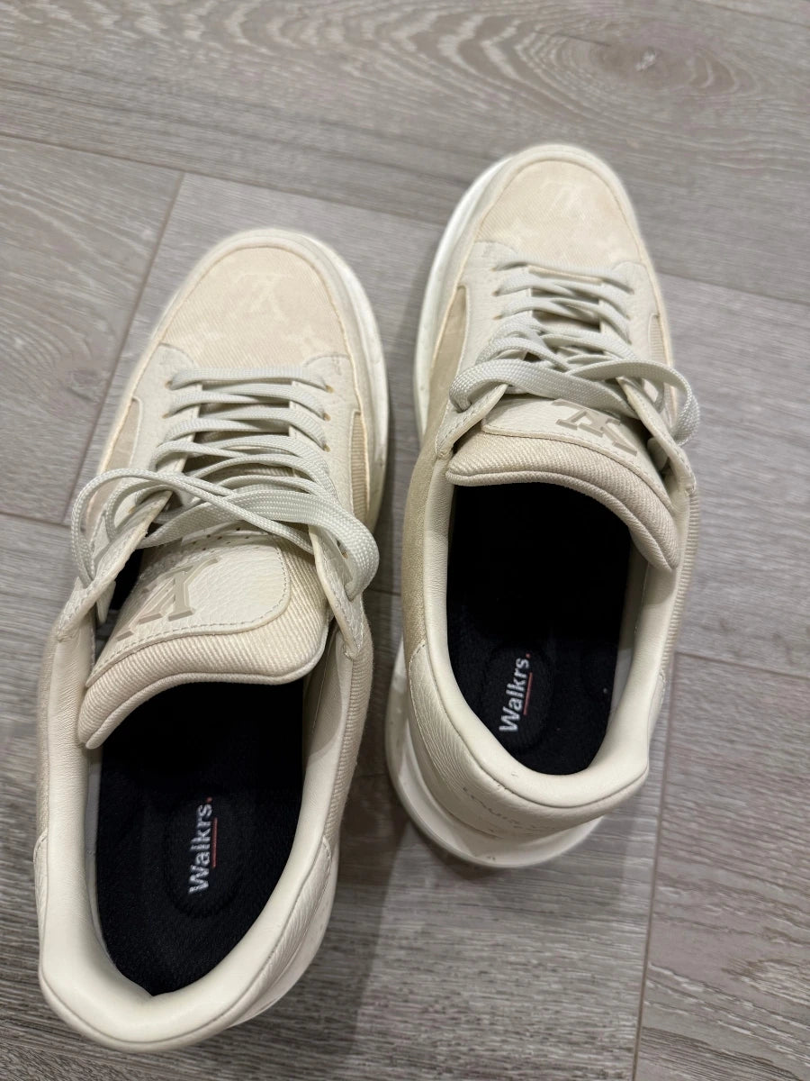 Walkrs insole inside a pair of white sneakers